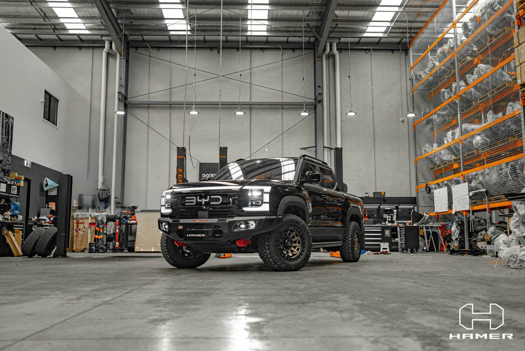 Black truck in a warehouse setting with visible HAMER logo.